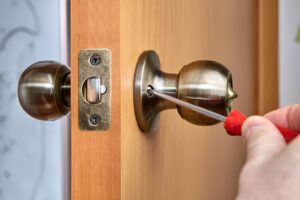 Locksmith fitting a lock on a converted flat in South Kensington